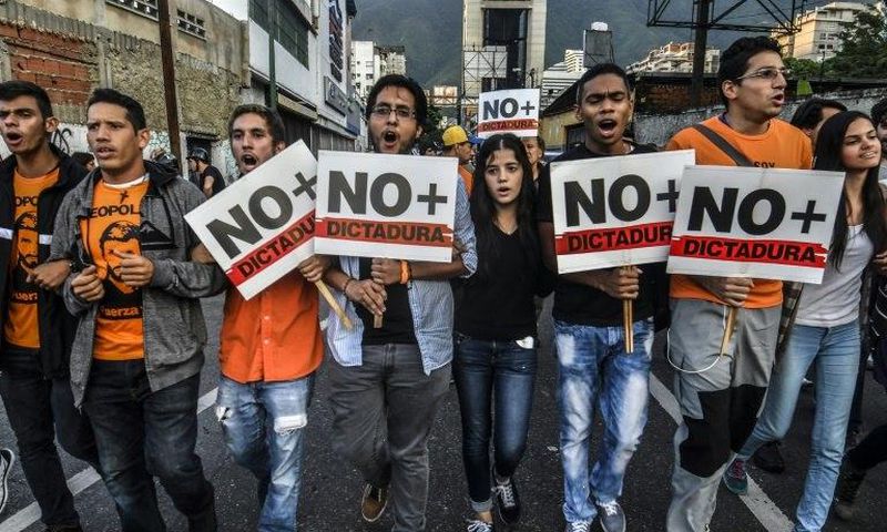 Opposition demonstrators march towards the Organisation of American States (OAS) headquarters in Caracas on June 21, 2017, after the 47th OAS General Assembly taking place in Cancun, Mexico, ruled out issuing a resolution on Venezuela