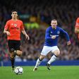 Everton's English striker Wayne Rooney (C) prepares to challenge MFK Ruzomberok's Kristi Qose (L) during the UEFA Europa League third qualifying round, Game 1 match July 27, 2017