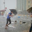 A man holds an umrella during a heavy downpour of hail at Taksim in Istanbul on July 27, 2017