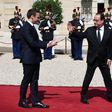 Hollande (right) leaving the Elysee Palace at the end of his formal handover to President Emmanuel Macron (left) on May 14 this year