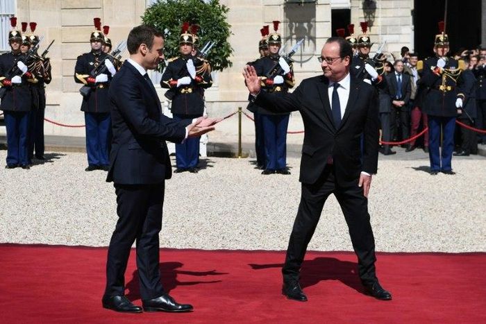 Hollande (right) leaving the Elysee Palace at the end of his formal handover to President Emmanuel Macron (left) on May 14 this year