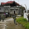 Philippine Marines taking cover from sniper fire while on patrol at the frontline in Marawi on the southern island of Mindanao