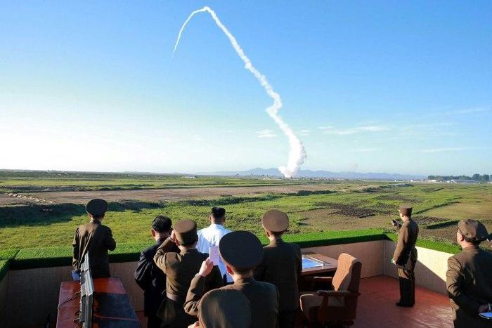 North Korean leader Kim Jong-Un (C, in white shirt) watches the test of a new anti-aircraft guided weapon system organized by the Academy of National Defence Science at an undisclosed location, in an undated picture released on May 28, 2017