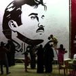 Qataris write comments on a wall bearing a portrait of Qatar's Emir, Sheikh Tamim bin Hamad Al Thani, which has become the symbol of Qatari resistance during the row between Doha and neighbouring countries, in Doha on July 6, 2017