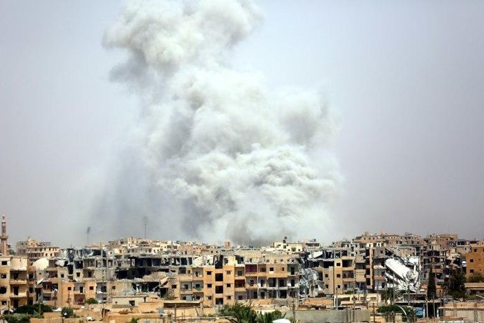 Smoke billows out from Syria's Raqa after a US-led coalition air strike on July 28, 2017, as US-backed forces battle the Islamic State group inside the city