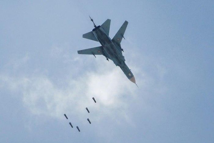 A Syrian warplane drops a payload on the rebel-held area of Qabun east of Damascus on May 6, 2017