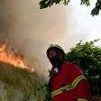 A firefighter looks on as he works to extinguish a wildfire in Carvalho, next to Pampilhosa da Serra