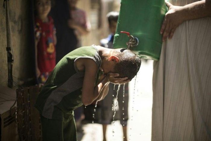 Israel is to supply millions of cubic metres of water to Palestinians including in the Gaza Strip, where a Palestinian boy is seen here cooling off with water from a jerrycan during a heatwave on July 2, 2017