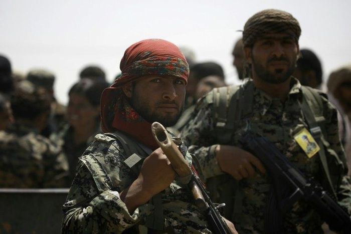 Members of the US-backed Syrian Democratic Forces (SDF) stand in the village of Hazima on the northern outskirts of the Islamic State (IS) group's Syrian bastion of Raqa on June 6, 2017