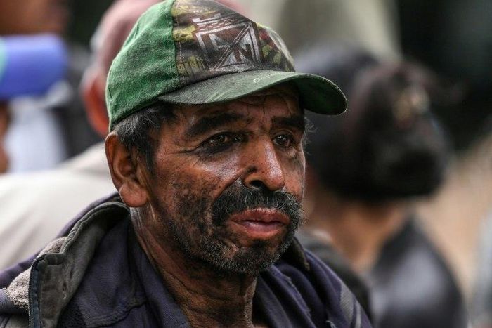 A miner waits for news during search operations at the illegal coal mine in the town of Cucunuba, central Colombia