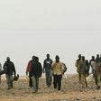 African migrants walk in the middle of the Sahara Desert on October 8, 2005