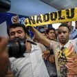 French football player Mathieu Valbuena (C) is greeted by fans as he arrives at Ataturk International airport in Istanbul, Turkey in June