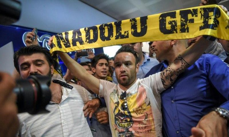 French football player Mathieu Valbuena (C) is greeted by fans as he arrives at Ataturk International airport in Istanbul, Turkey in June