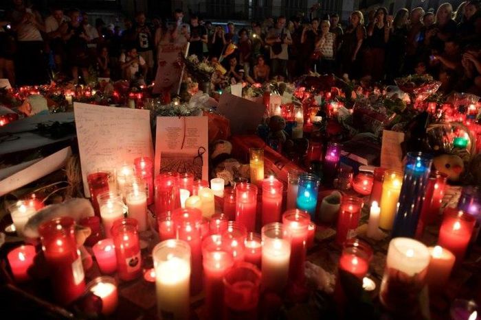 People pay tribute to the victims of the Barcelona terror attack at a makeshift memorial on the Las Ramblas boulevard