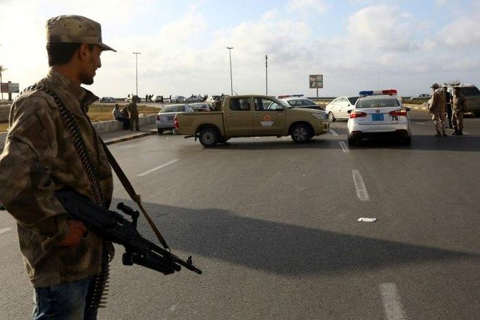 Forces loyal to Libya's Government of National Accord (GNA) man a checkpoint in the Hay al-Andalus neighbourhood of Tripoli on March 14, 2017, following clashes between rival armed groups