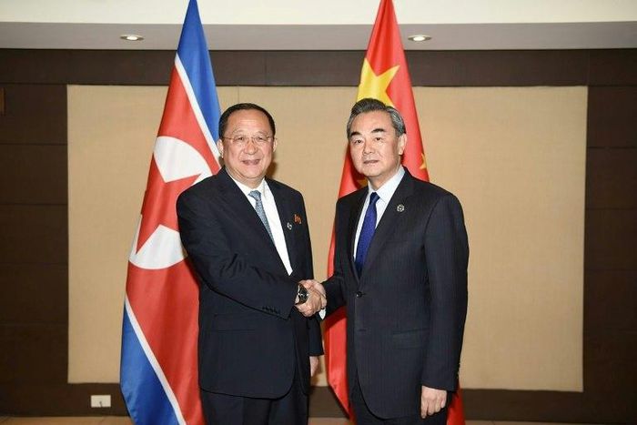 China's Foreign Minister Wang Yi (R) shakes hands with North Korea's Foreign Minister Ri Yong-Ho (L) during their bilateral meeting