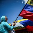 An anti-government activist demonstrates against Venezuelan President Nicolas Maduro on a barricaded road in Caracas on Tuesday