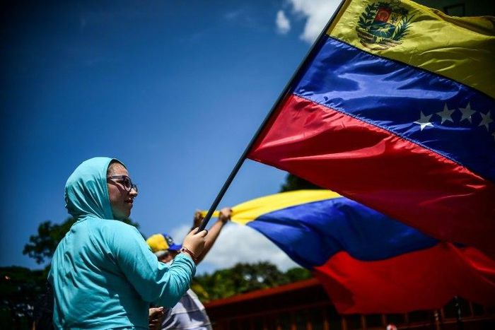 An anti-government activist demonstrates against Venezuelan President Nicolas Maduro on a barricaded road in Caracas on Tuesday