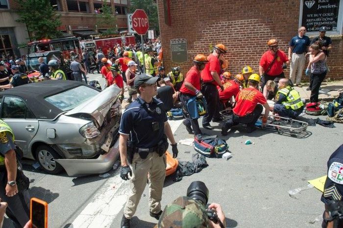 A woman receives first-aid after a car plows into a crowd in Charlottesville, Virginia after a rally by white nationalists turns violent