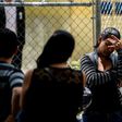 A relative of one of the victims of the club stampede waits outside the morgue in Caracas