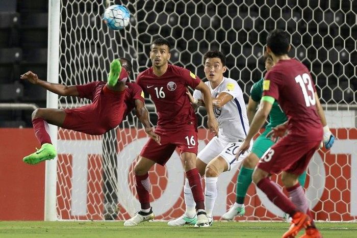 Qatar's Mohammed Kasoala (L) attempts a shot on goal during their 2018 World Cup Asia qualifying match against South Korea, at the Jassim Bin Hamad stadium in Doha, on June 13, 2017