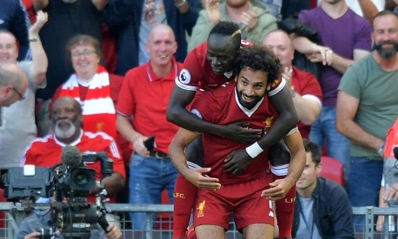 Liverpool's Mohamed Salah (R) celebrates with Sadio Mane after scoring their third goal during their match against Arsenal Liverpool, north west England on August 27