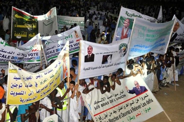 This photo taken on July 20, 2017 shows supporters of Mauritanian President gathering and holding banners during a rally ahead of the constitutional referendum on scrapping the senate and changing the national flag, in Nouakchott