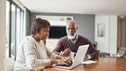 older couple doing paperwork at home