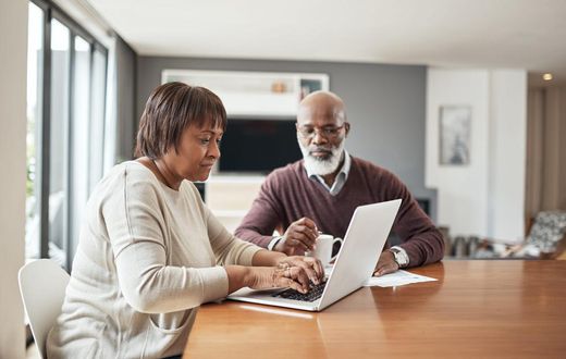 older couple doing paperwork at home