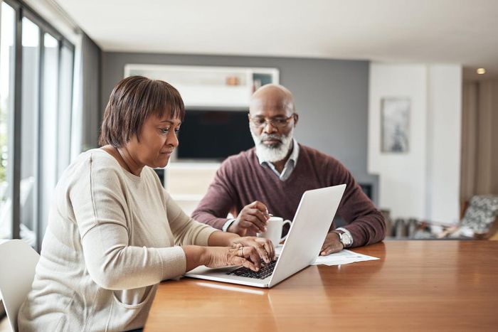 older couple doing paperwork at home