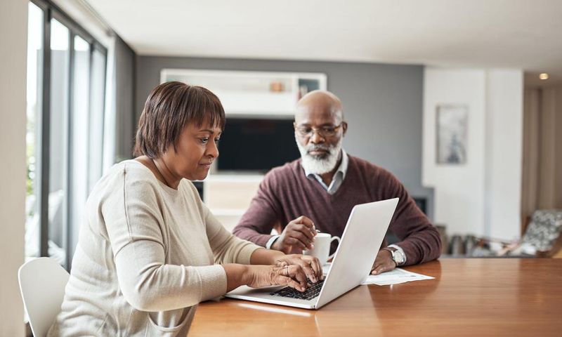 older couple doing paperwork at home