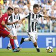 Juventus' forward Paulo Dybala (R) fights for the ball with Cagliari's midfielder Luca Cigarini during the Italian Serie A football match August 19, 2017