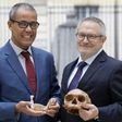 French paleoanthropologist Jean-Jacques Hublin (R) and Abdelouahed Ben-Ncer of the National Institute of Archaeology and Heritage Sciences in Morocco pose with the casting of a skull of Homo Sapiens discovered in Morocco on June 6, 2017 in Paris