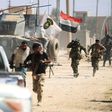 Iraqi forces advance through Tal Afar's Al-Wahda district during an operation to retake the city from the Islamic State group on August 24, 2017