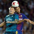 Barcelona's Sergio Busquets (R) fights for the ball with Real Madrid's Toni Kroos during their Spanish Super Cup first leg match, at Camp Nou in Barcelona, on August 13, 2017