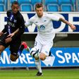 Rajiv van la Parra (L), then of Dutch club Herenveen, is challenged by Molde's Knut Olav Rindaroy during a UEFA Europa League third round qualifying match on August 23, 2012