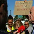French rights watchdog head Jacques Toubon speaks with migrants during a visit to a humanitarian reception centre for migrants in Paris on Friday.