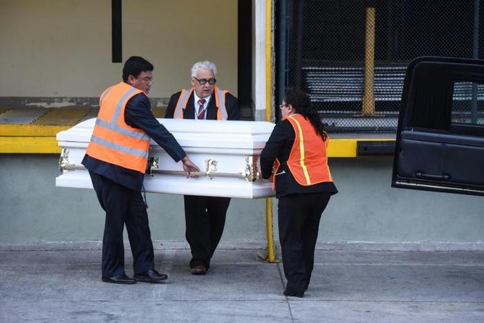 Employees of a funeral home carry a coffin with the repatriated remains of seven-year-old Guatemalan migrant girl Jakelin Caal