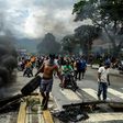 Venezuelan opposition activists build a barricade during clashes in Valencia, on August 6, 2017