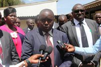 Governor Alex Tolgos speaking to members of the press