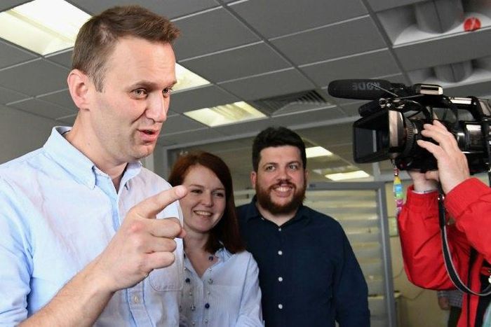 Russian opposition leader Alexei Navalny makes a statement for media at his office in Moscow shortly after being released from jail