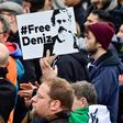An activist displays a placard calling for Deniz Yucel's release during a concert organised in front of Berlin's Brandenburg Gate on the occasion of International Press Freedom Day on May 3, 2017