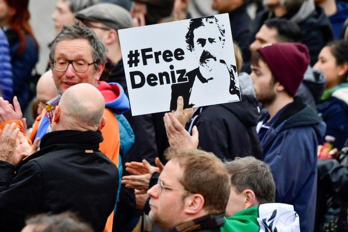 An activist displays a placard calling for Deniz Yucel's release during a concert organised in front of Berlin's Brandenburg Gate on the occasion of International Press Freedom Day on May 3, 2017