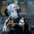 An Israeli border guard fires tear gas at Palestinian protesters near the Jewish settlement of Beit El in the occupied West Bank on July 24, 2017