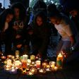 People light candles after a silent march in memory of the victims of the Grenfell Tower fire