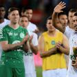 Chapecoense's defender Alan Ruschel waves as he holds the second place trophy at the Camp Nou stadium in Barcelona on August 7, 2017