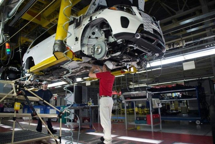 An employee installs parts on the undercarriage of a Mercedes-Benz GLS-Class SUV at the Mercedes-Benz US International factory in Vance, Alabama on June 8, 2017.