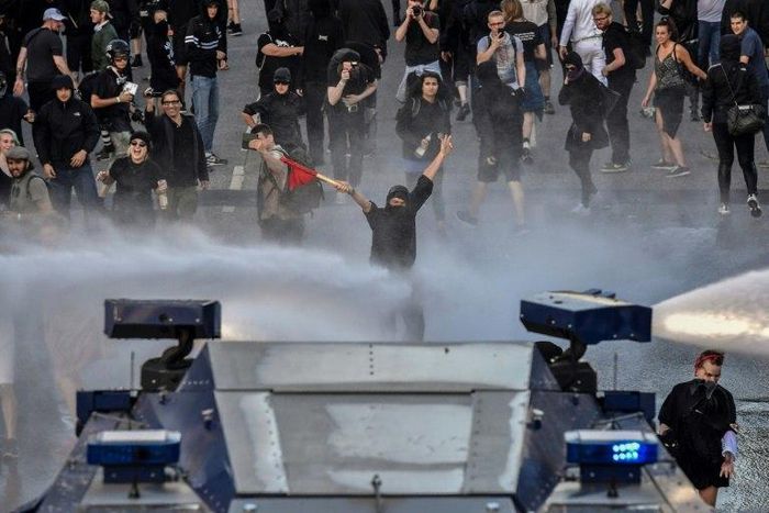 Protesters are doused with water during the "Welcome to Hell" rally against the G20 summit in Hamburg, northern Germany on July 6, 2017