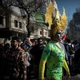 Carrying rainbow flags and banners, participants in Santiago's Gay Pride Parade, some dressed in drag, marched through the city's streets on July 1, 2017