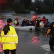 People are rescued from the Omni hotel by boat after Hurricane Harvey caused heavy flooding in Houston